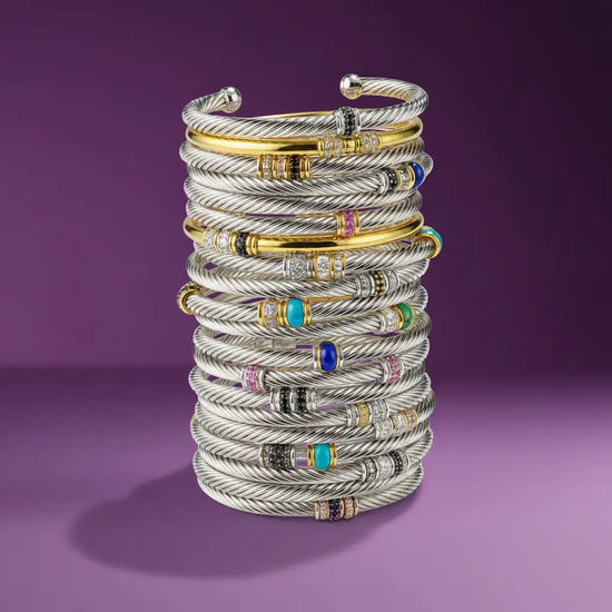 18k gold and silver cable bracelets with colorful gemstone accents.