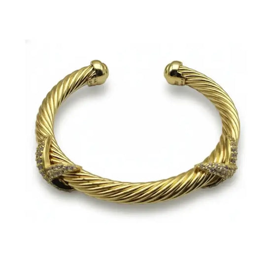 Gold-toned twisted cable bracelet with diamond accents at the clasp.