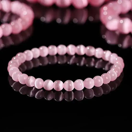 Rose quartz beaded bracelet with smooth, round beads and a delicate design.