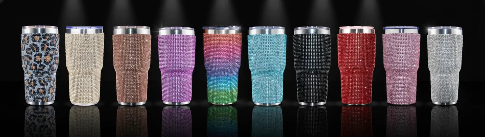 A row of sparkling, rhinestone-encrusted insulated tumblers in various colors and patterns including leopard print.