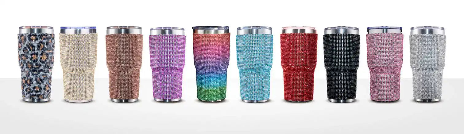 A row of ten glitter-covered tumbler cups in various colors and patterns.