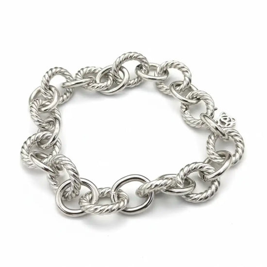 Silver twisted rope chain bracelet with a sleek, interlocking design and polished finish.