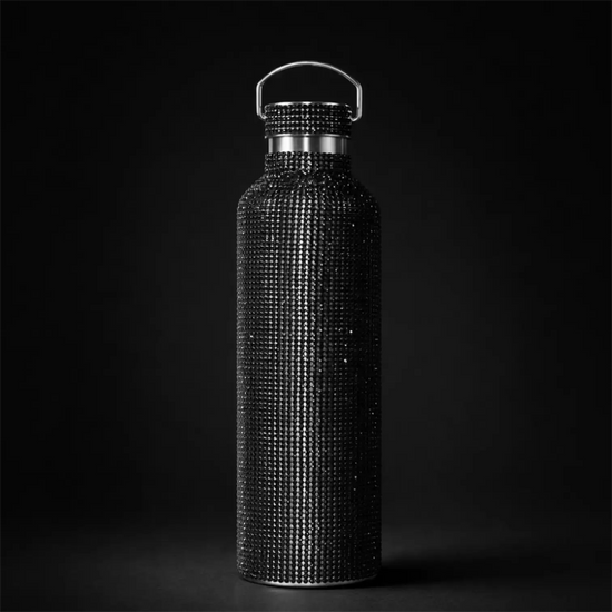 A sleek black water bottle adorned with a dense, sparkling array of rhinestones across its entire surface and featuring a silver-toned handle.