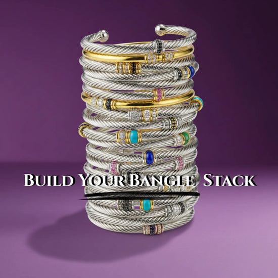 Stack of david yurman cable bracelets in silver and gold with gemstone accents.