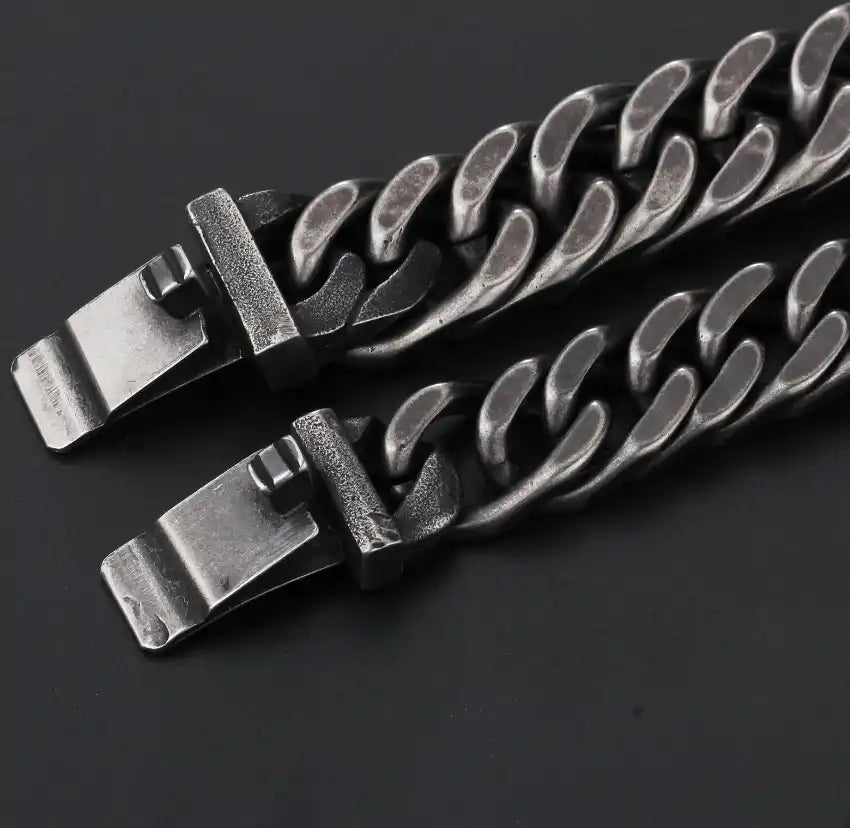 Two distressed silver-colored metal curb chain bracelets with clasp closures.