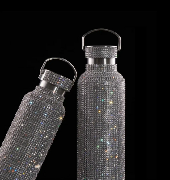Two dazzling rhinestone-encrusted water bottles.