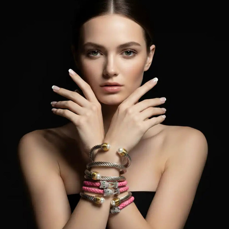A woman showcasing a collection of bracelets.